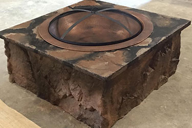 square copper and stone fire pit in Wisconsin